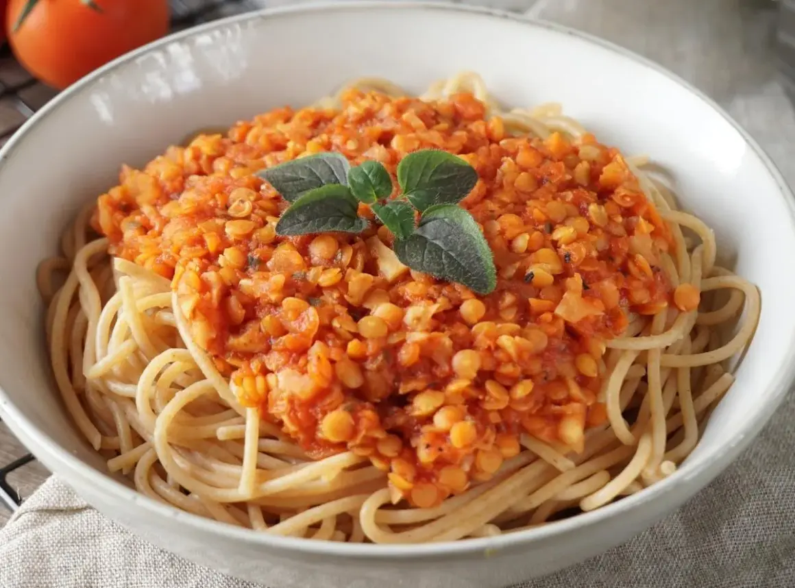 Herzhafte Linsen Bolognese auf Vollkornspaghetti, garniert mit frischen Kräutern. Ein köstliches, vegetarisches Gericht.