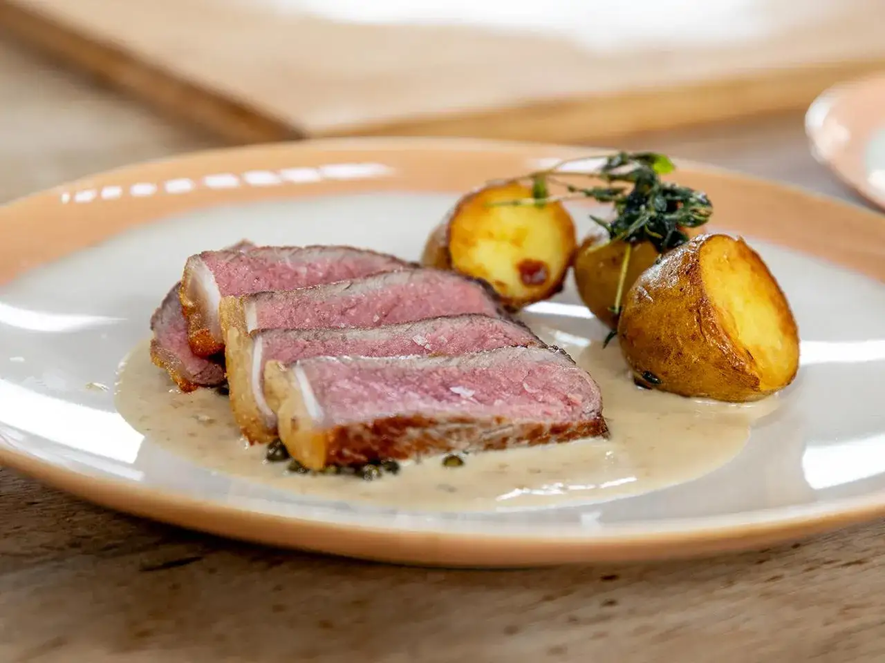 Perfekt gebratenes Rumpsteak, saftig und rosa, mit cremiger Sauce und knusprigen Kartoffeln. Ein Genuss, der Lust macht, Rumpsteak braten zu lernen.